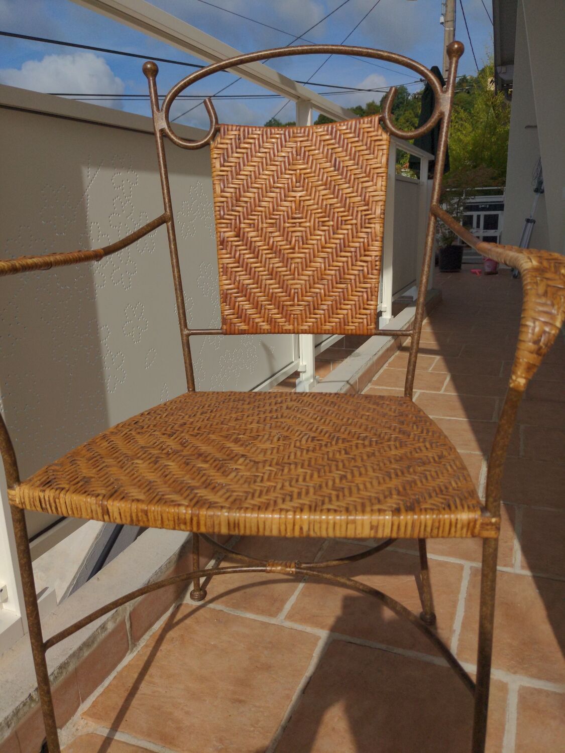 Wicker armchair and wrought iron
