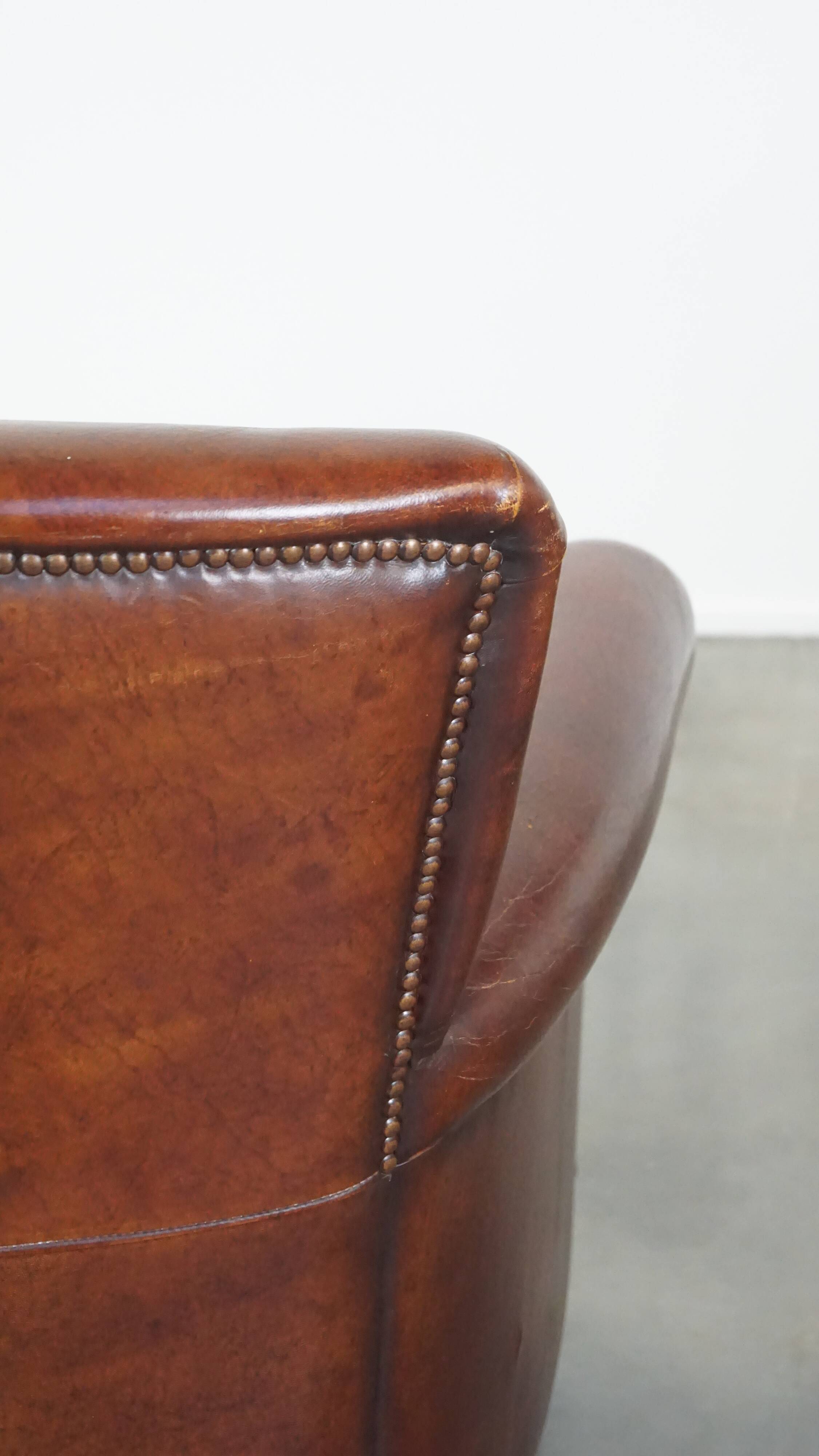 Sheep leather armchair correctly finished with decorative nails