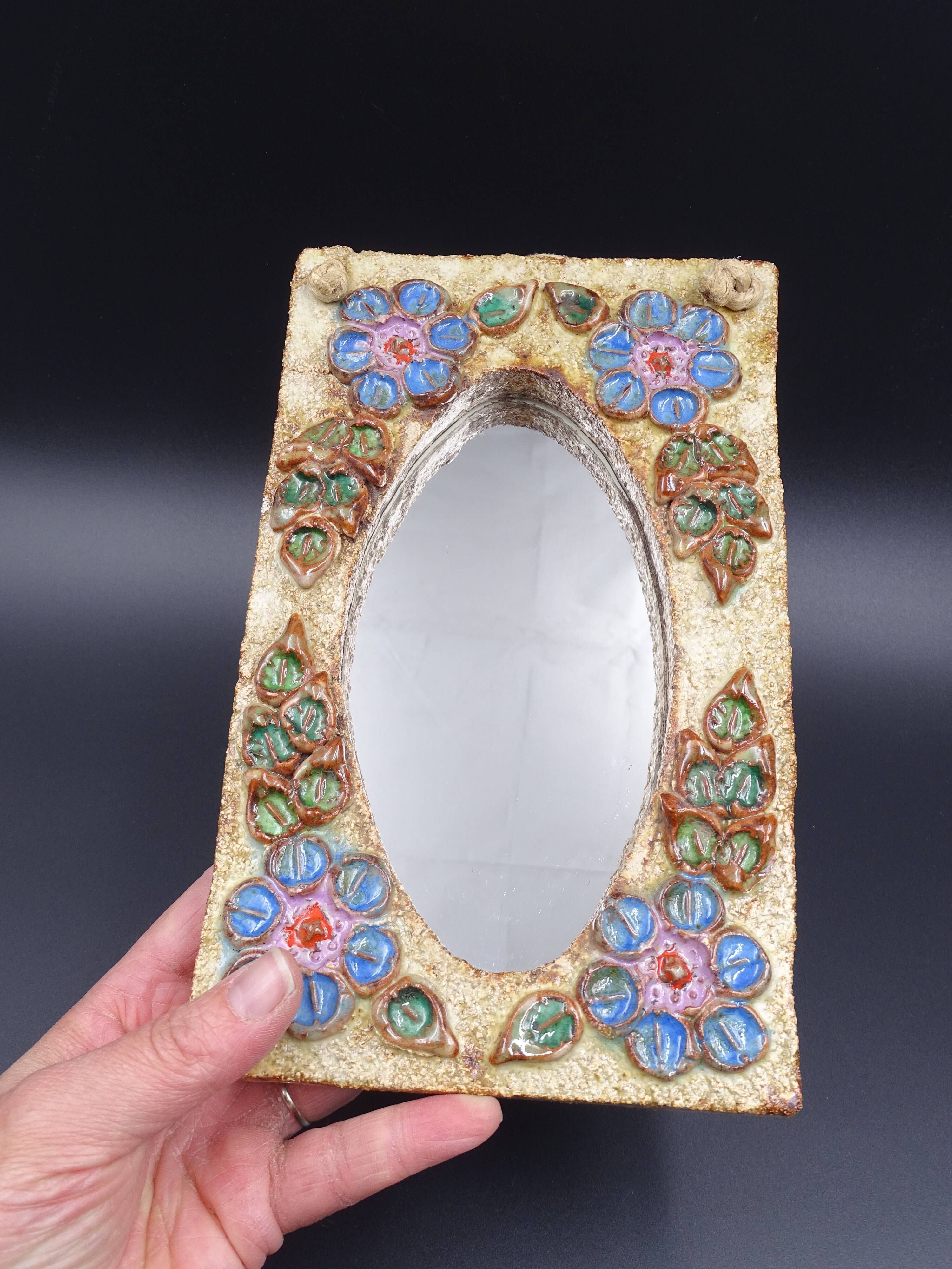 Flower-decorated sandstone mirror, circa 1970