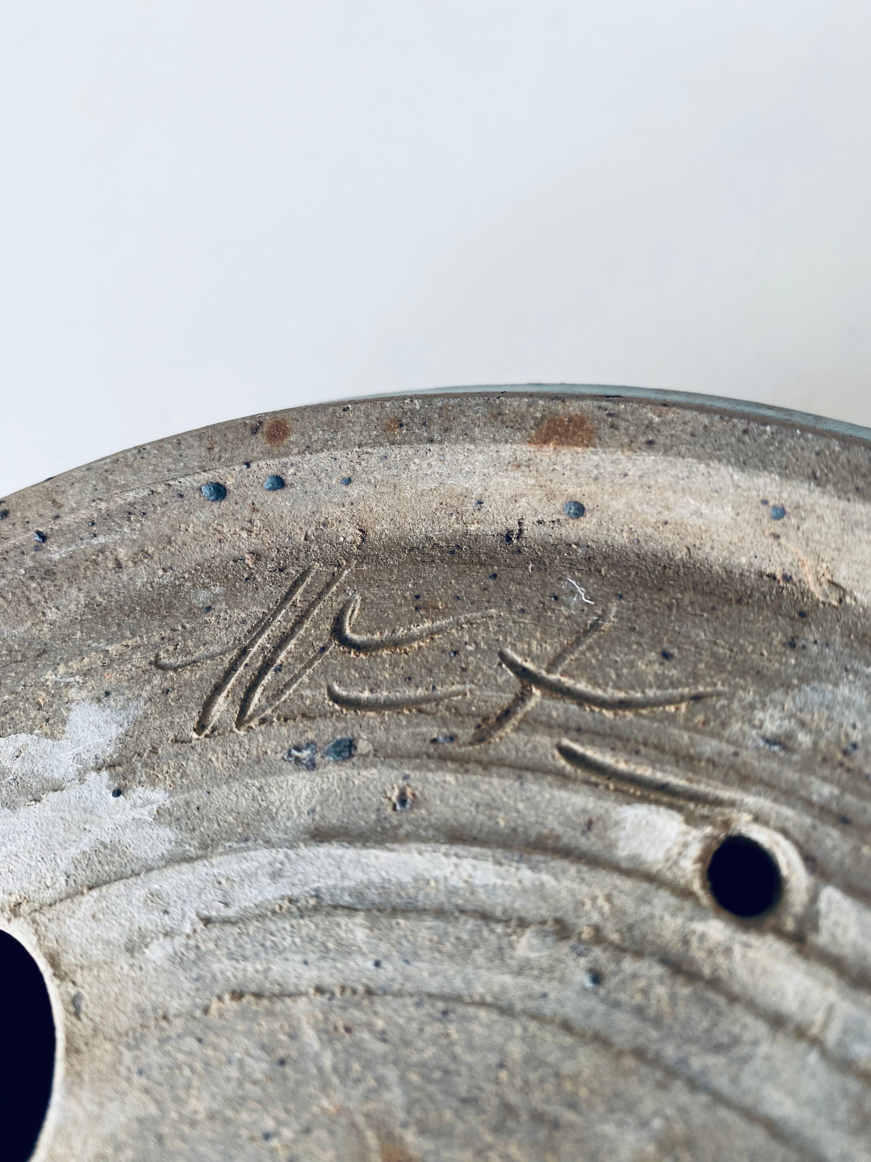 Pierced glazed stoneware cup