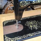 Old Singer sewing machine on pedestal