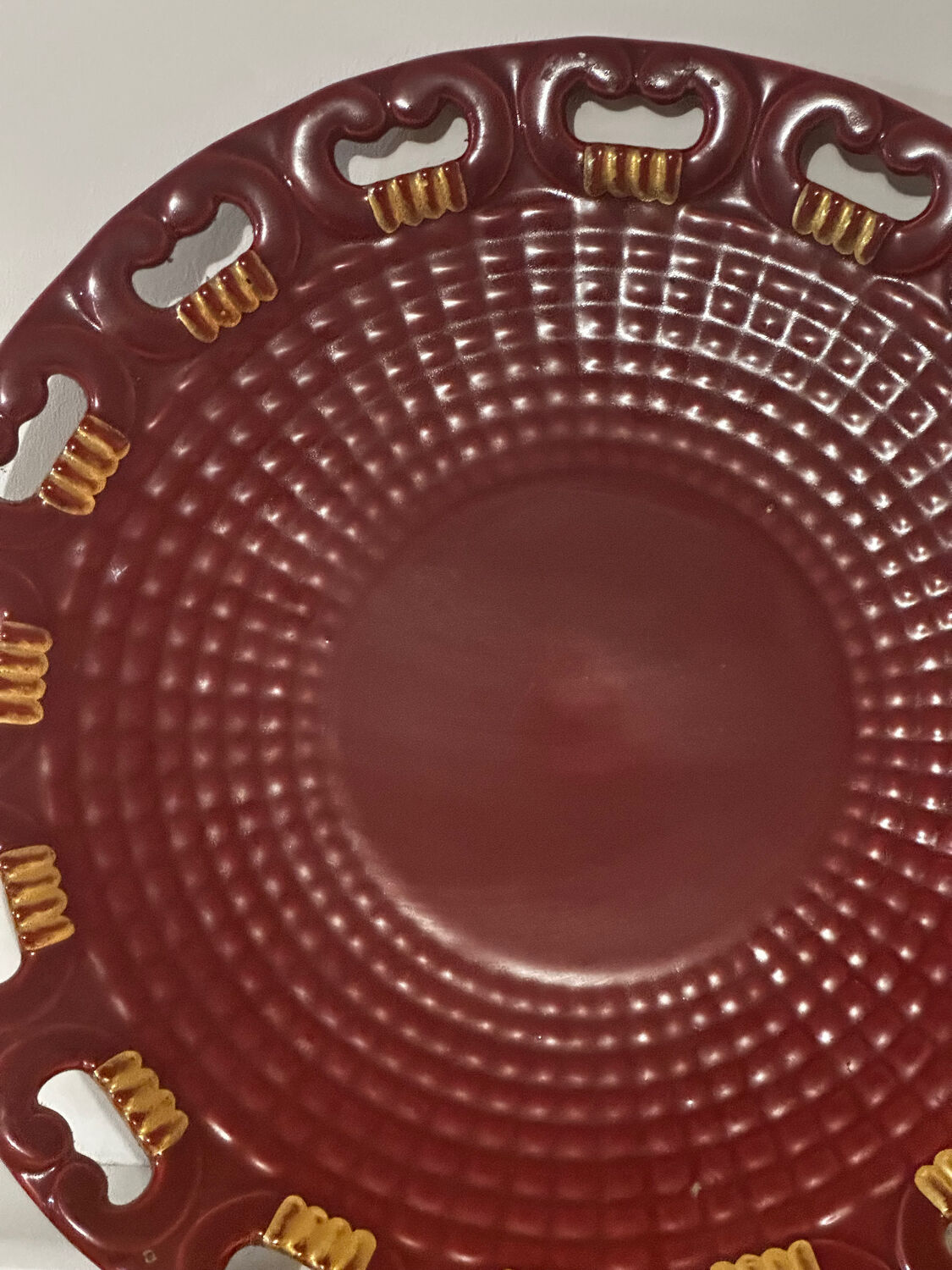 Burgundy and gold openwork plate in ceramic from Saint-Clement, 1950s.