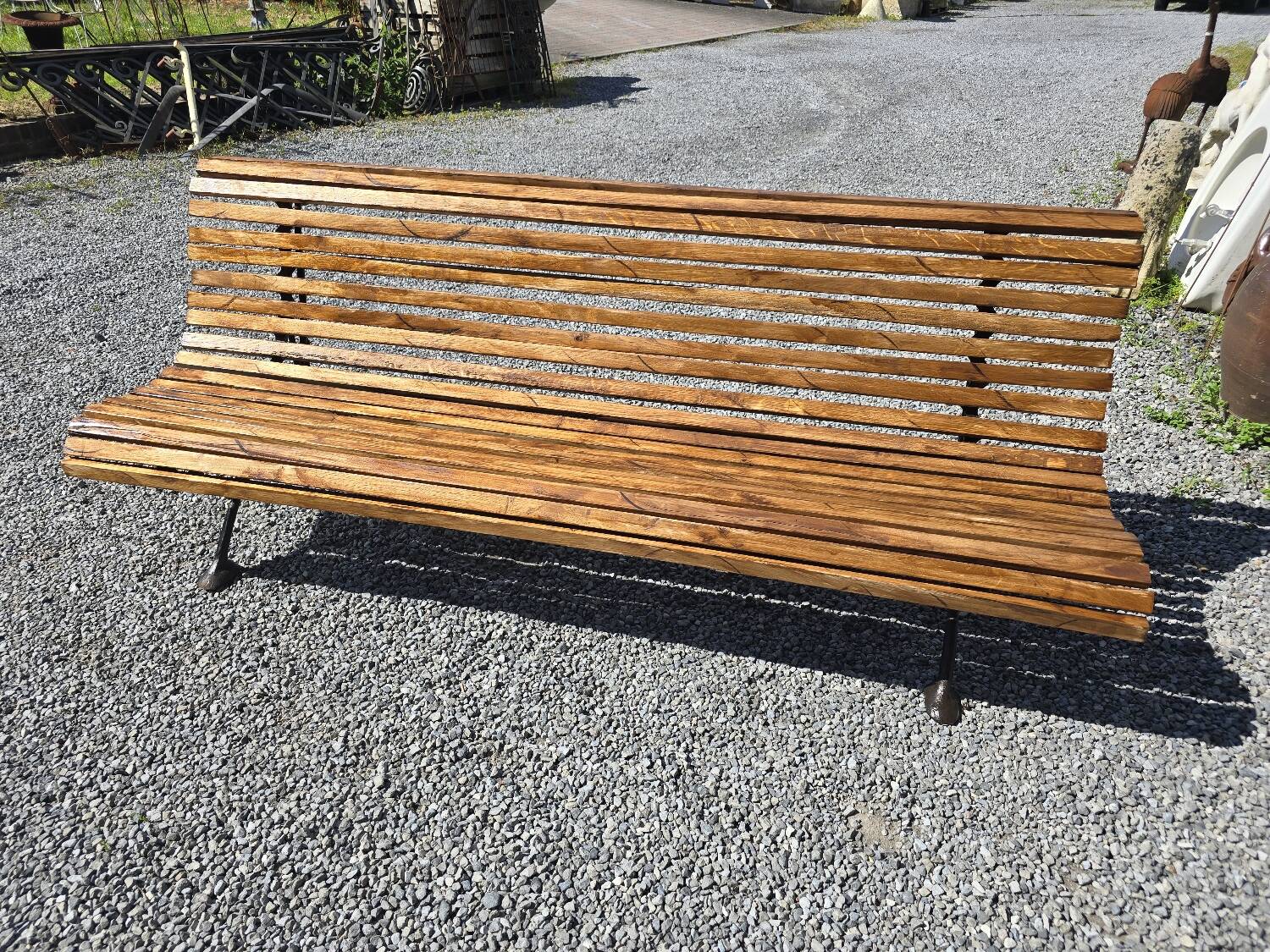 Wooden garden bench with cast iron base
