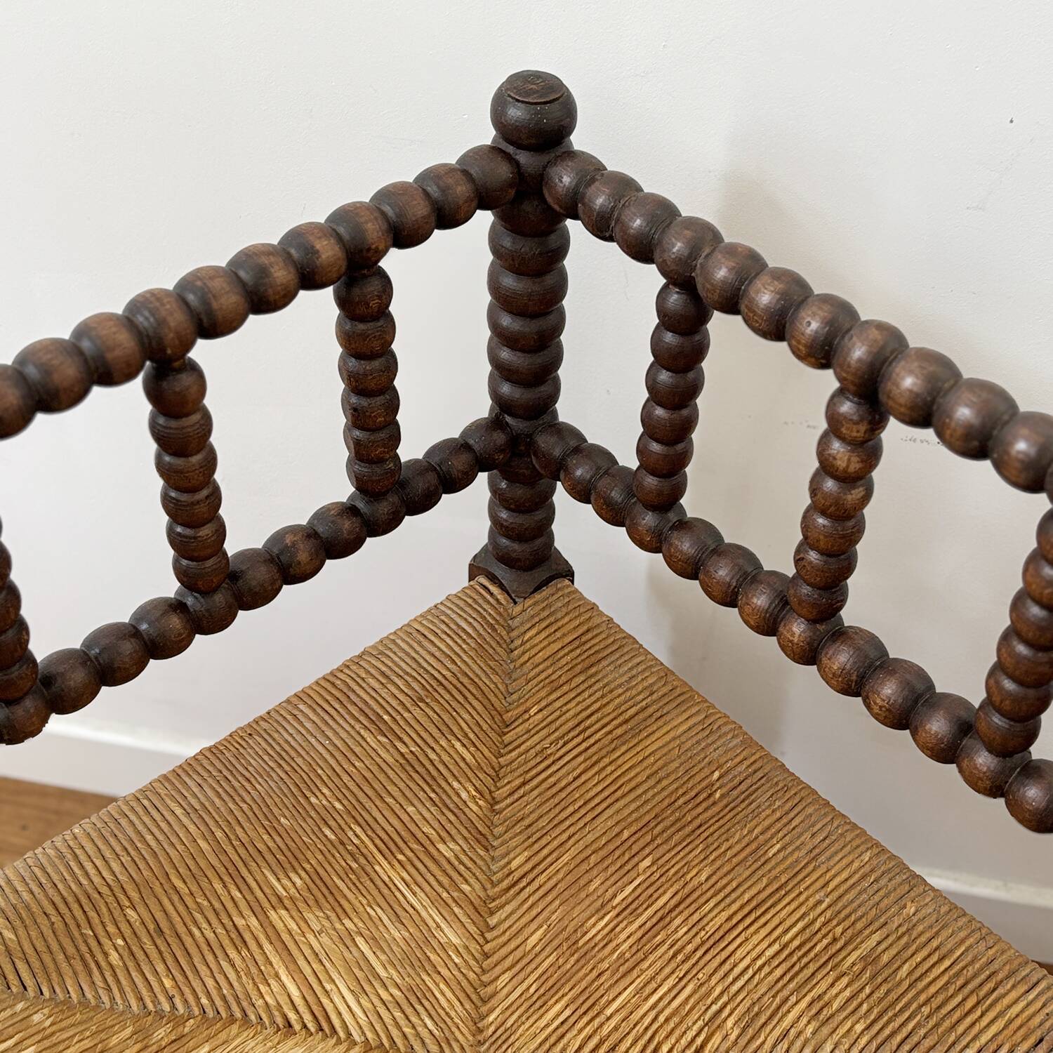 Turned wood corner chair with straw seat