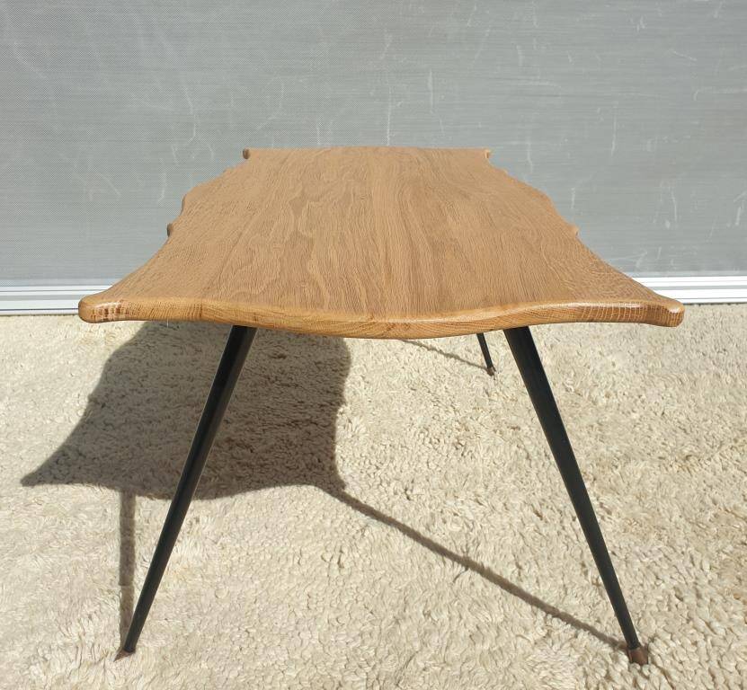 Violin-shaped coffee table with brass legs