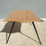 Violin-shaped coffee table with brass legs