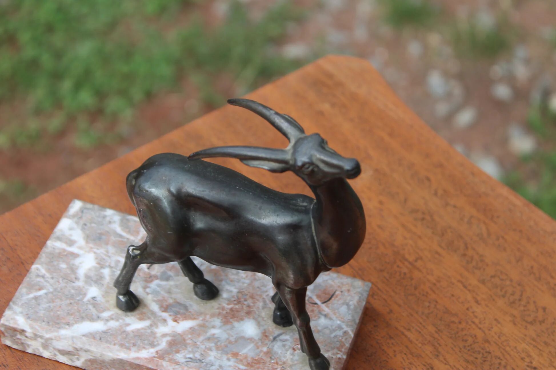 Vintage antelope gazelle bookend in patinated metal on a marble base.