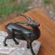 Vintage antelope gazelle bookend in patinated metal on a marble base.