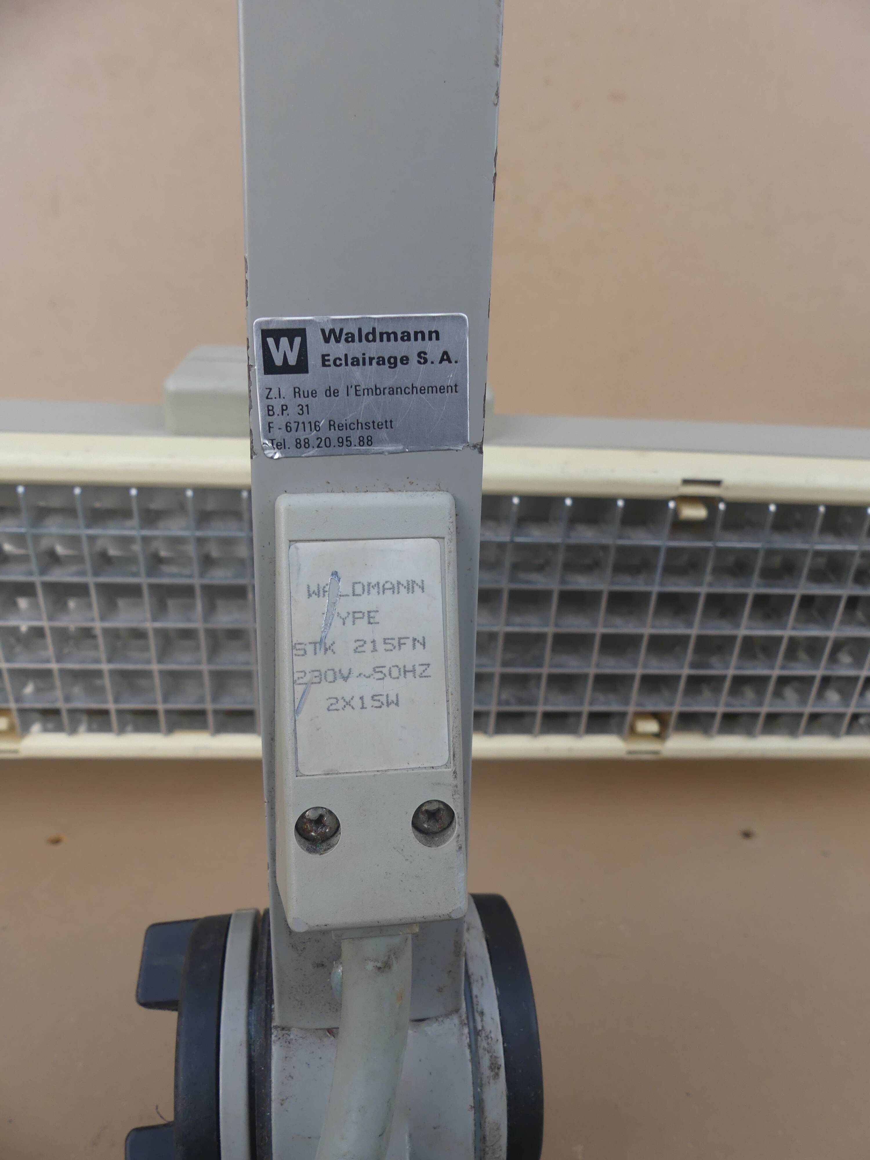 WALDMANN articulated workshop lamp with two industrial clamp arms for architects.