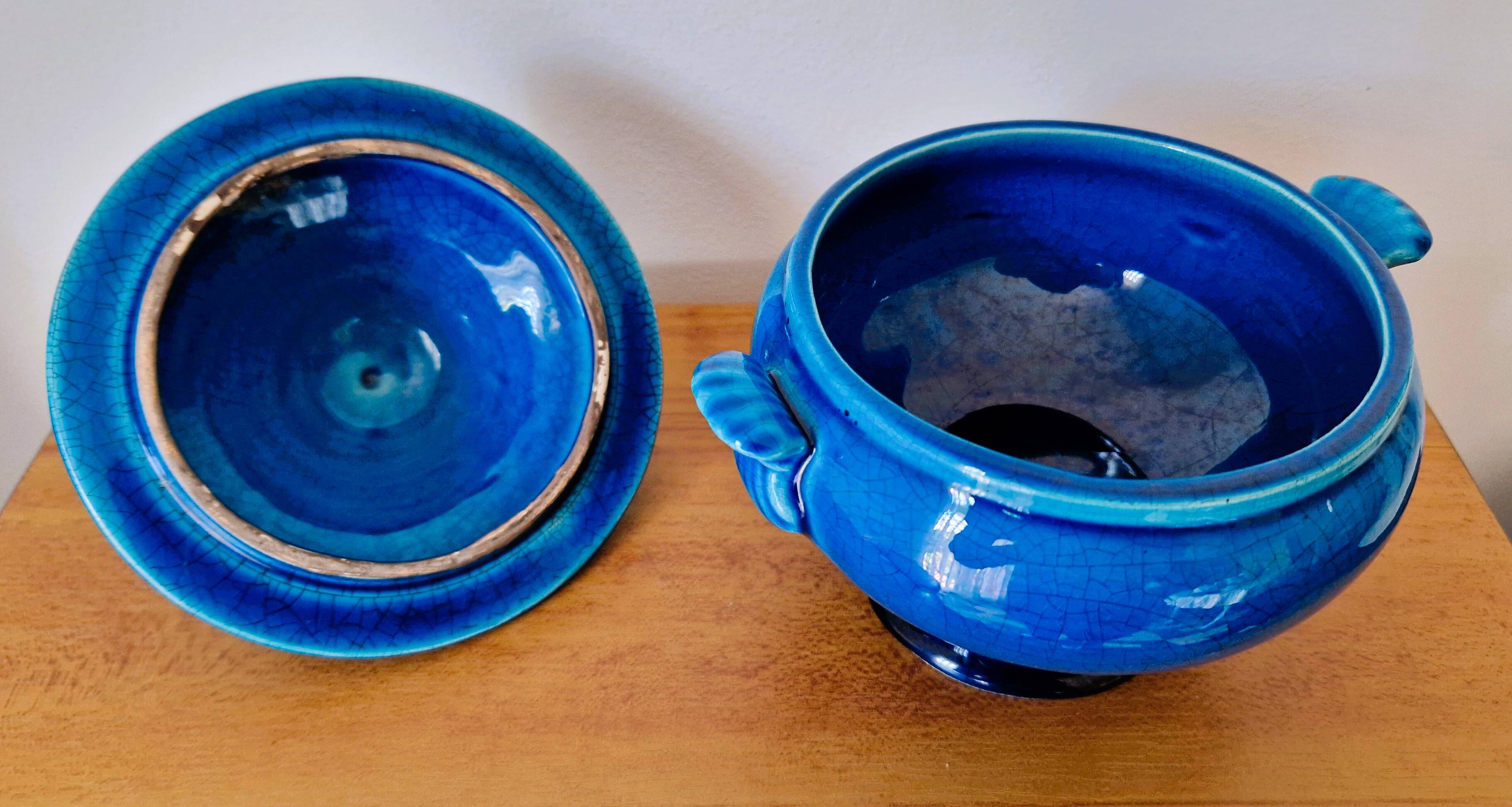 Blue ceramic soup tureen and crackled finish trivet.