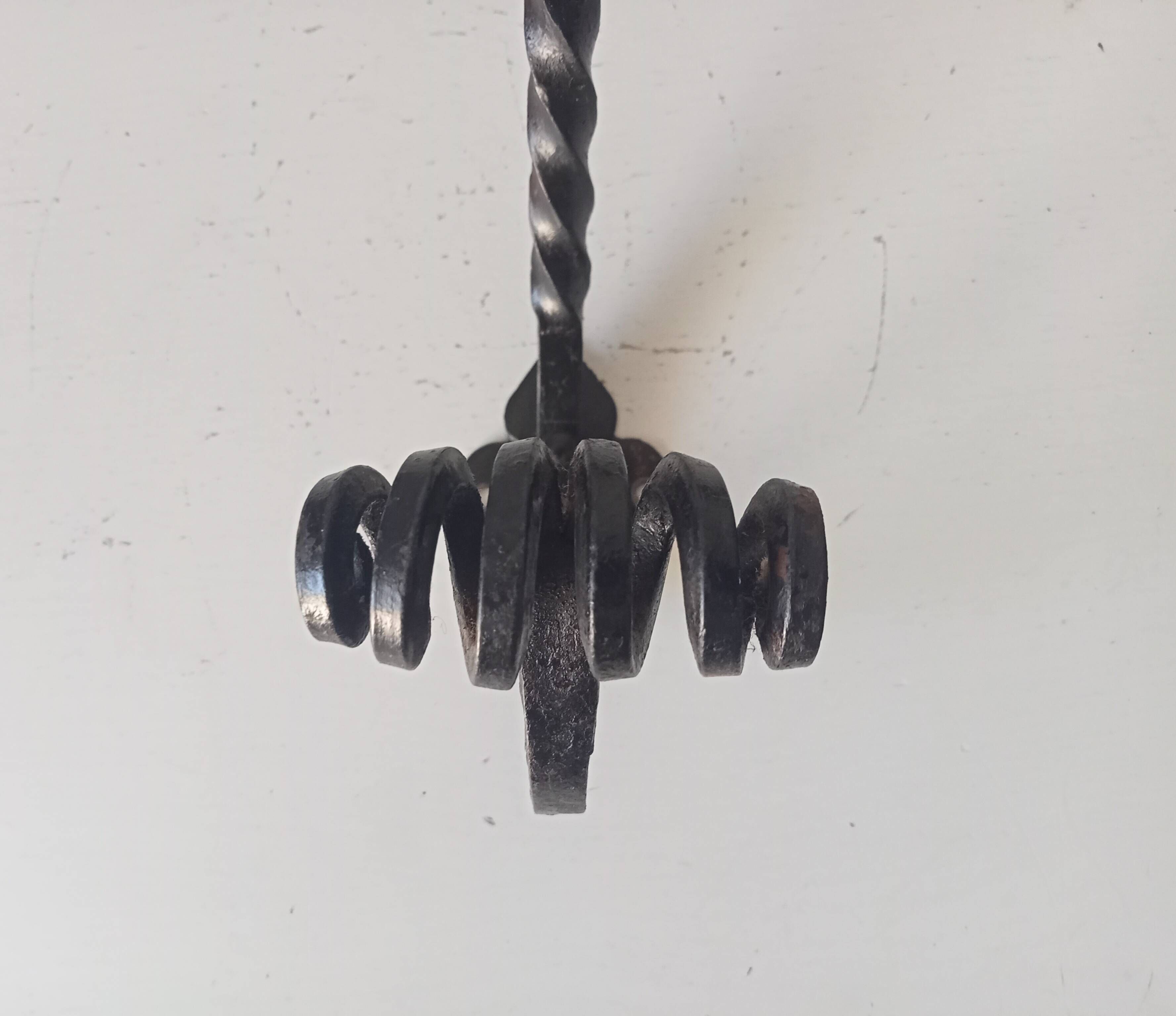 Brutalist wall coat rack in wrought iron.