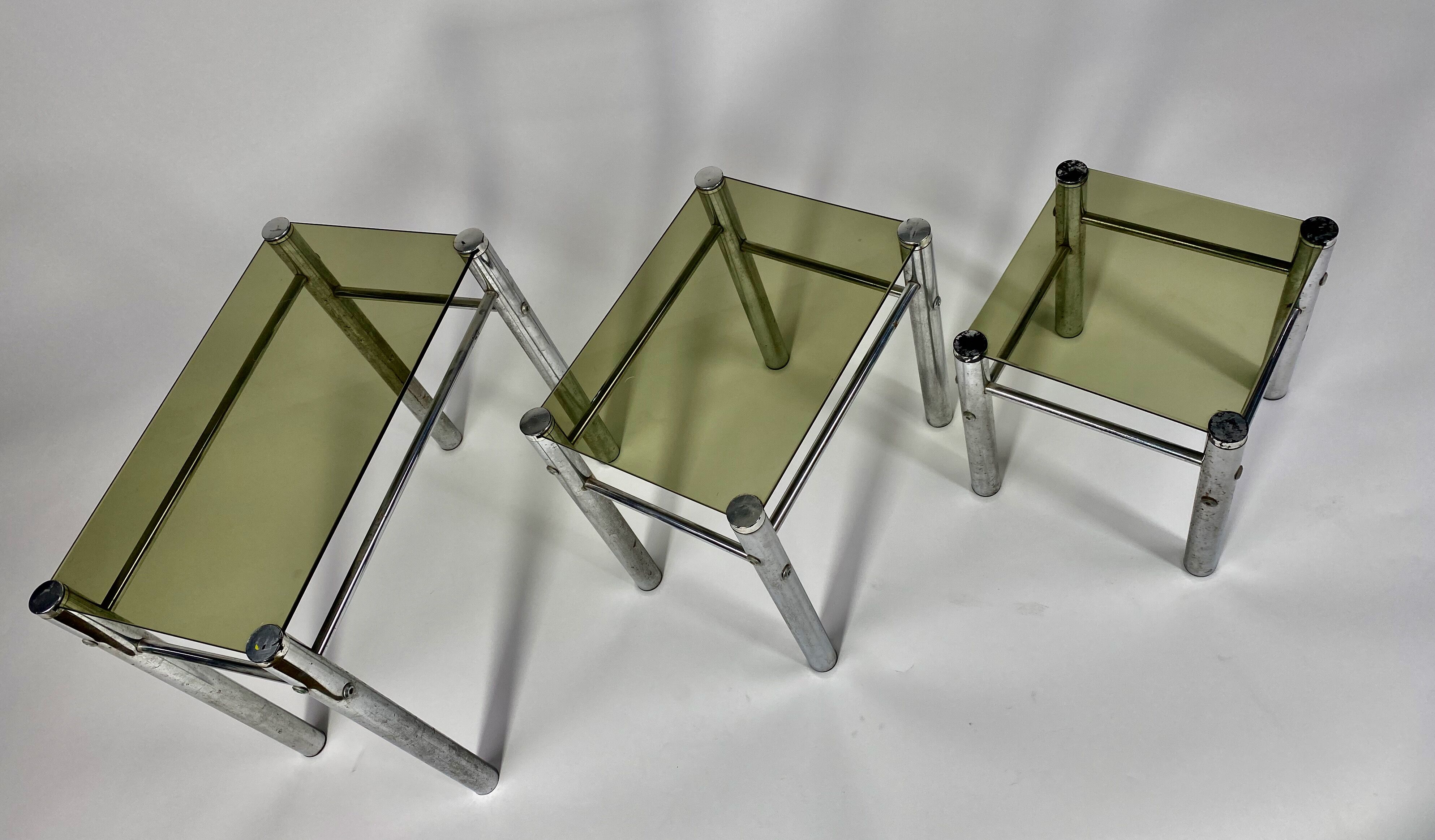 Tables in chrome metal and tinted glass. year 70