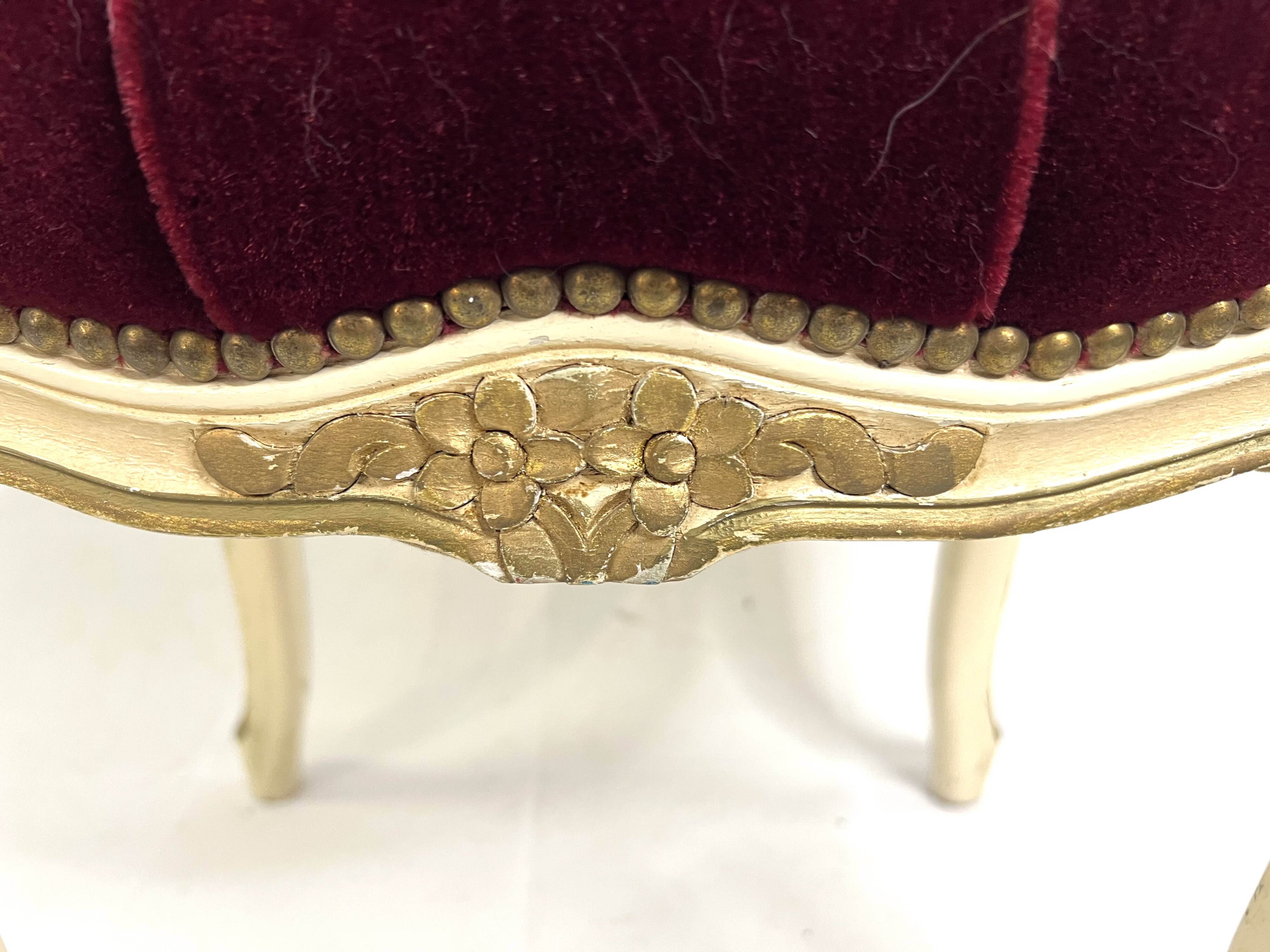 Antique upholstered stool in red velvet and carved wood