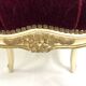 Antique upholstered stool in red velvet and carved wood