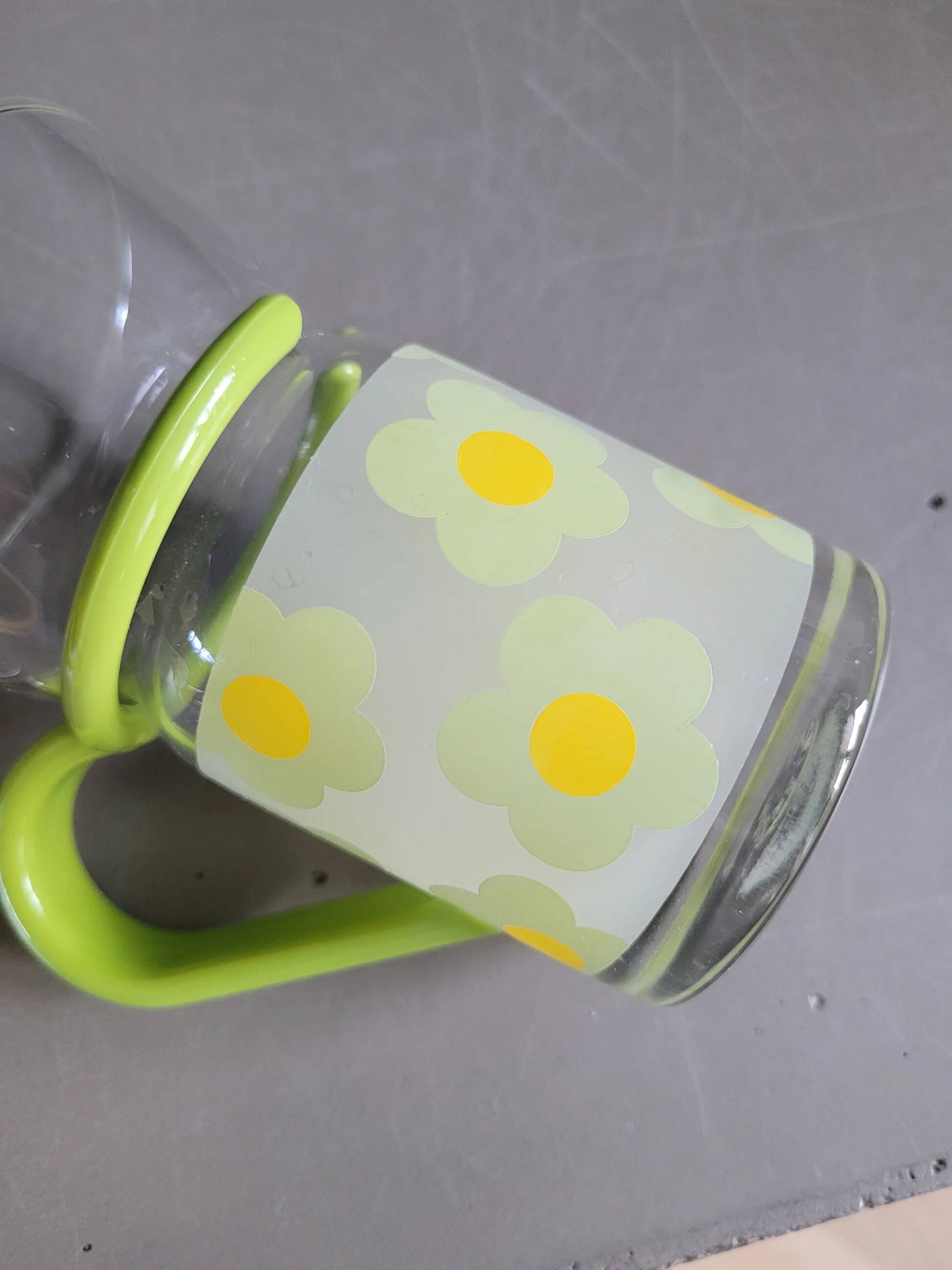 Pair of glass teacups with plastic handles
