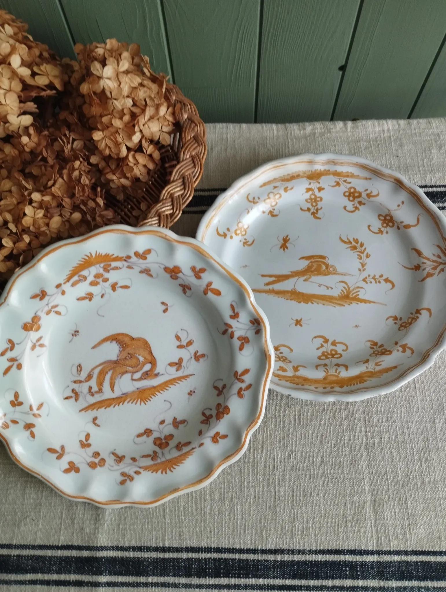 Pair of antique plates with a bird of paradise design in the style of Moustiers.