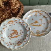 Pair of antique plates with a bird of paradise design in the style of Moustiers.