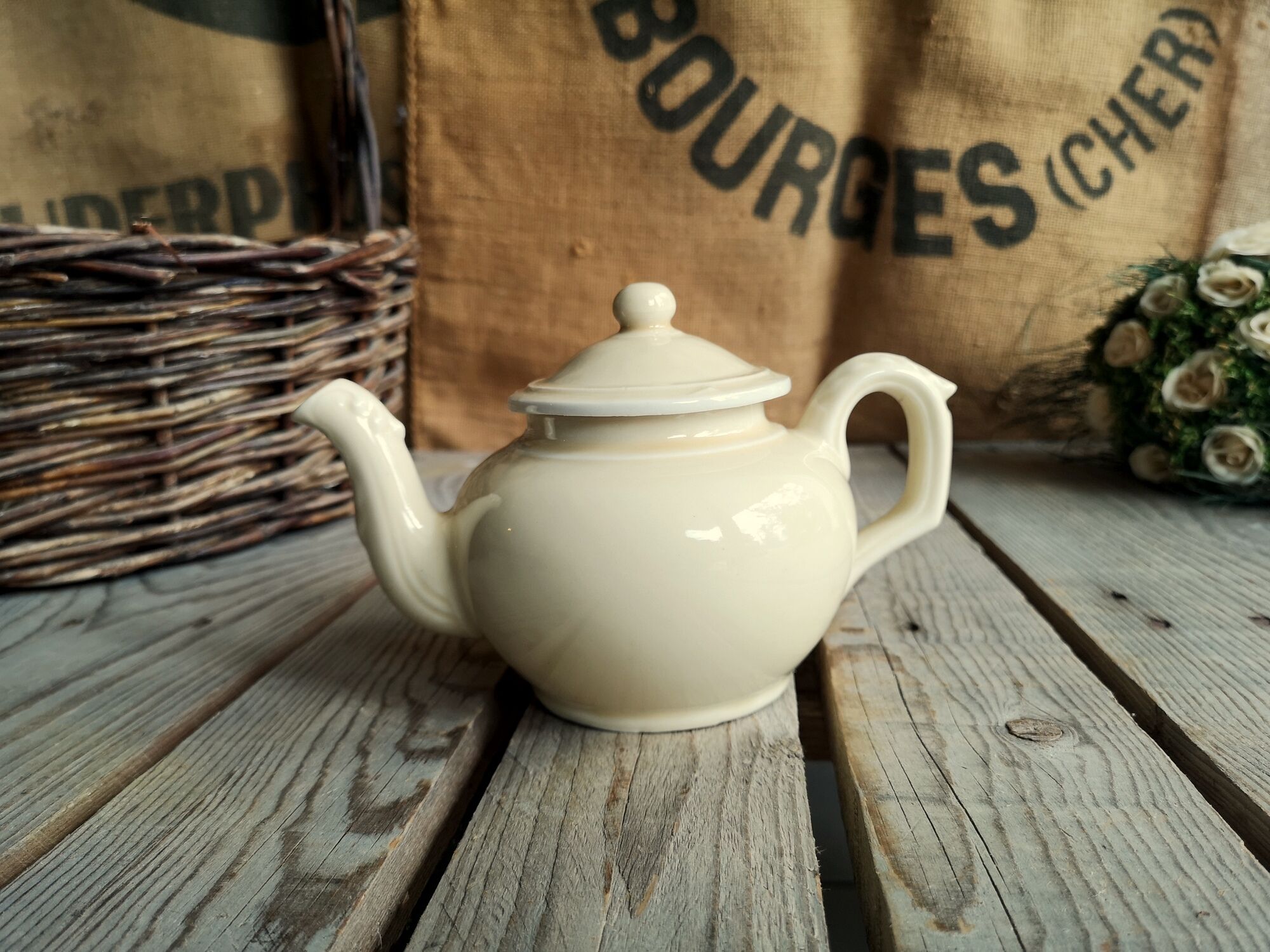 Little ancient teapot in ceramics color cream