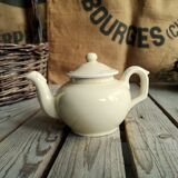 Little ancient teapot in ceramics color cream