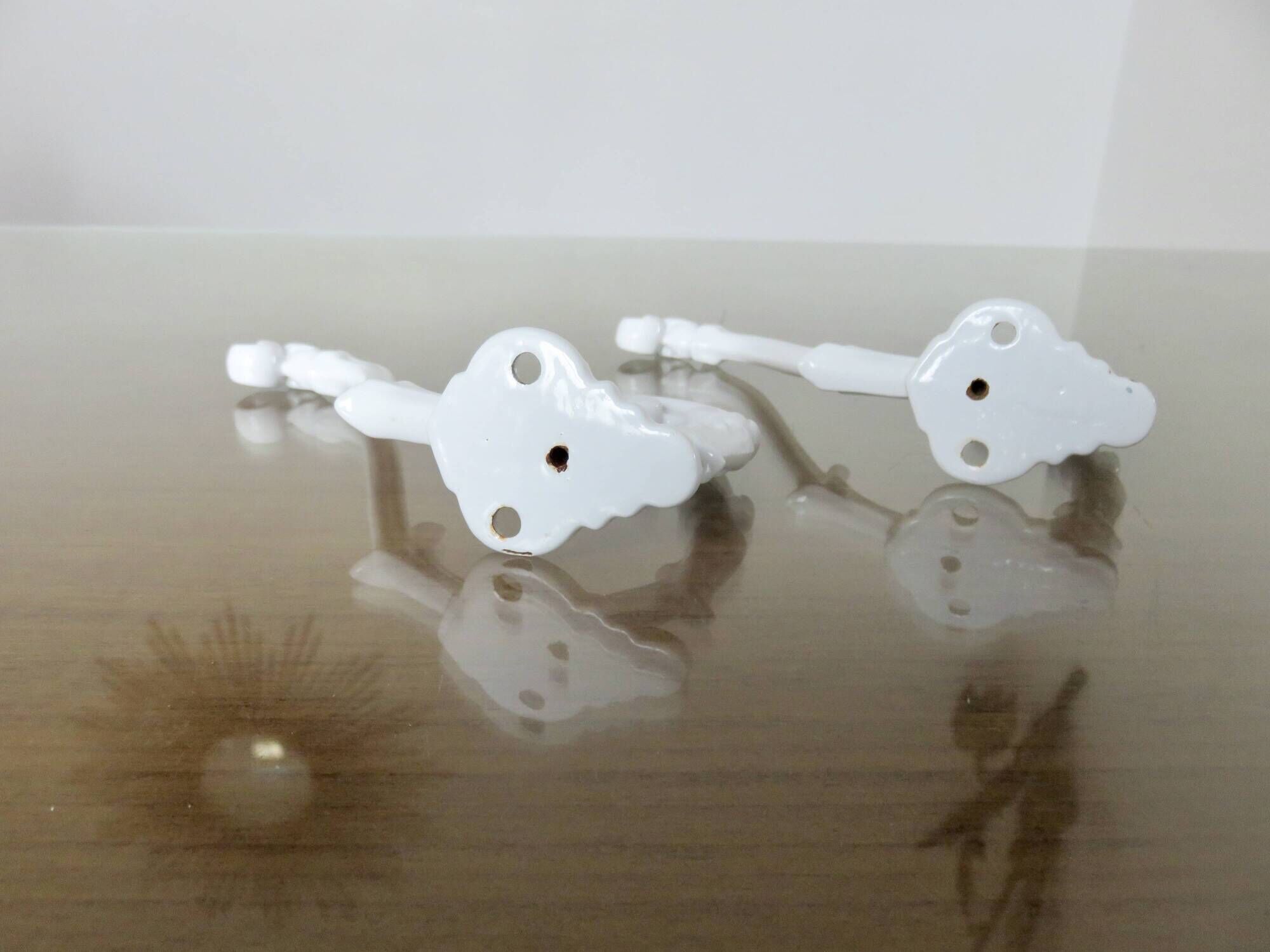 Pair of Art Deco white cast iron coat hooks from the 1930s and 1940s
