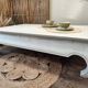 Exotic wood coffee table with its safety glass protection.