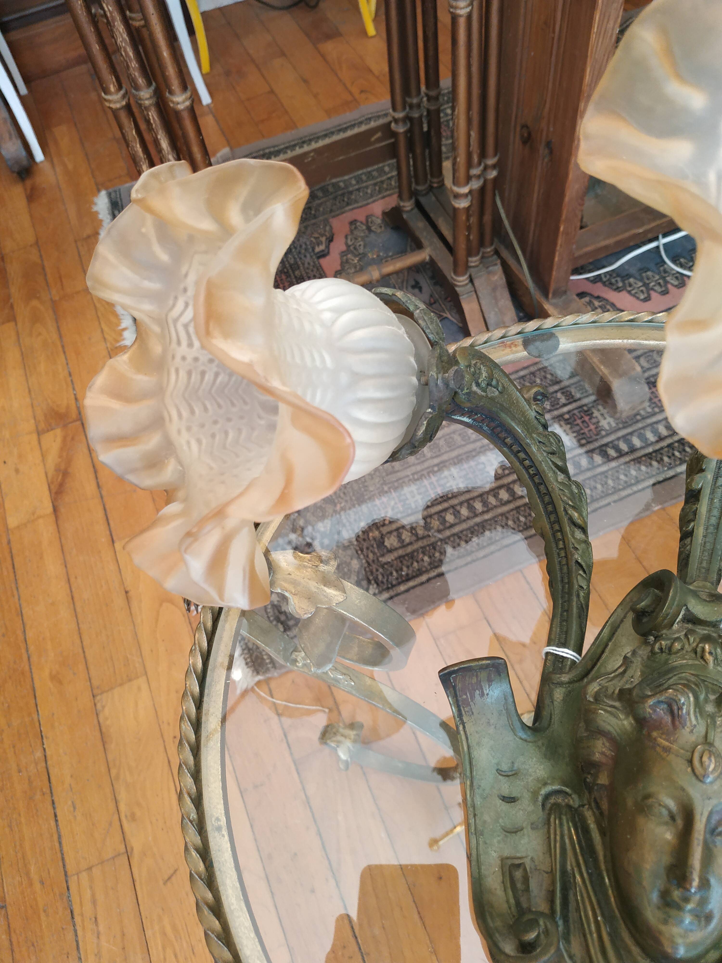 Bronze wall light patinated woman's head