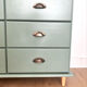 Low buffet with patinated gold handles.