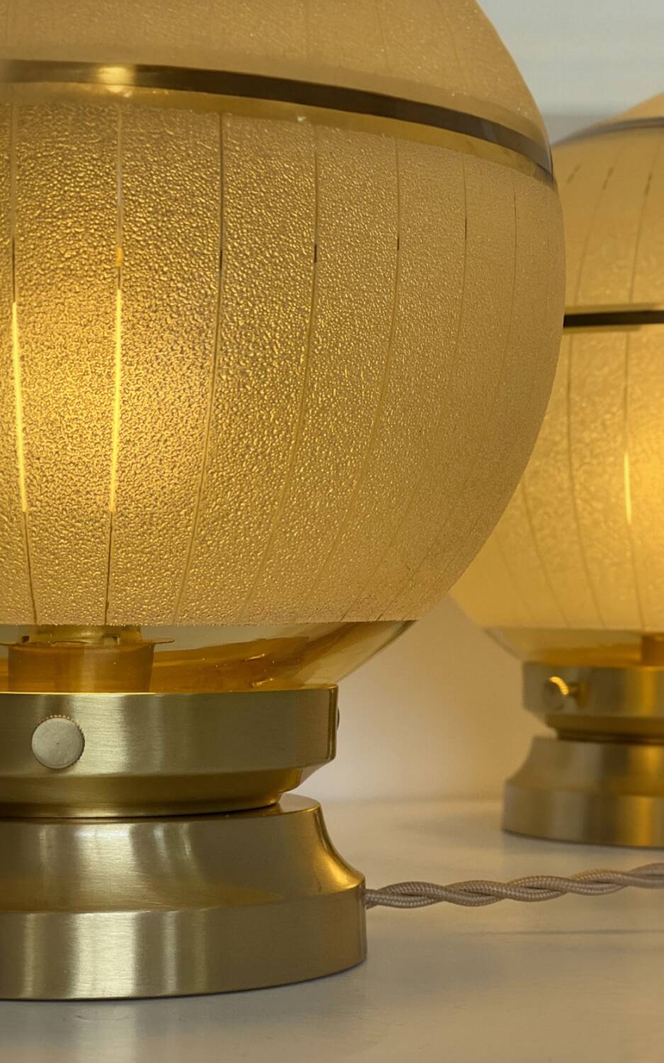 Pair of large art deco globe table lamps with brass legs