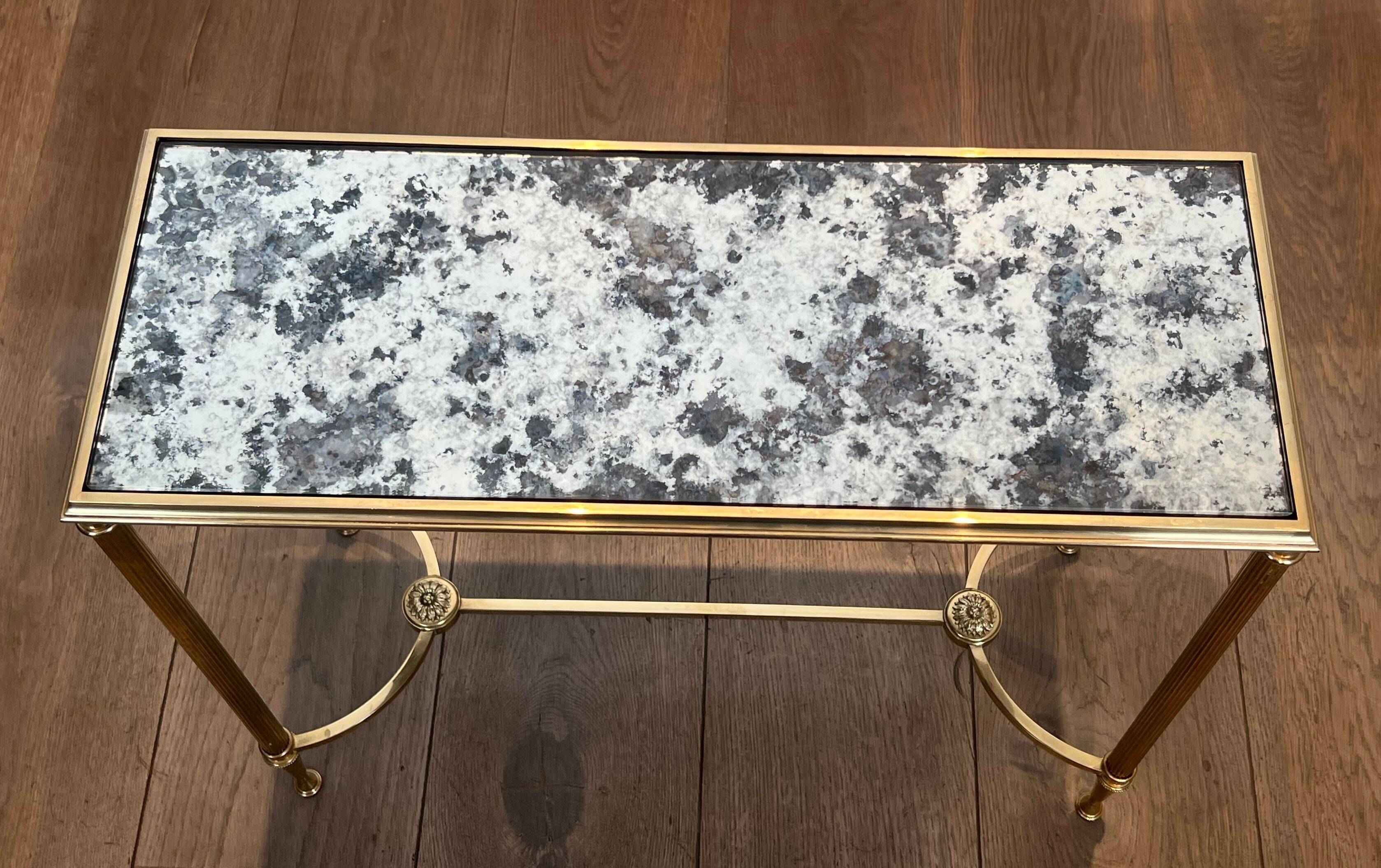 Pair of brass and antique mirror side tables from the Baguès house.