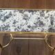 Pair of brass and antique mirror side tables from the Baguès house.