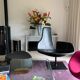 Fjord armchair by Moroso with its pouf, designed by Patricia Urquiola in 2002, made of steel and smooth black leather.