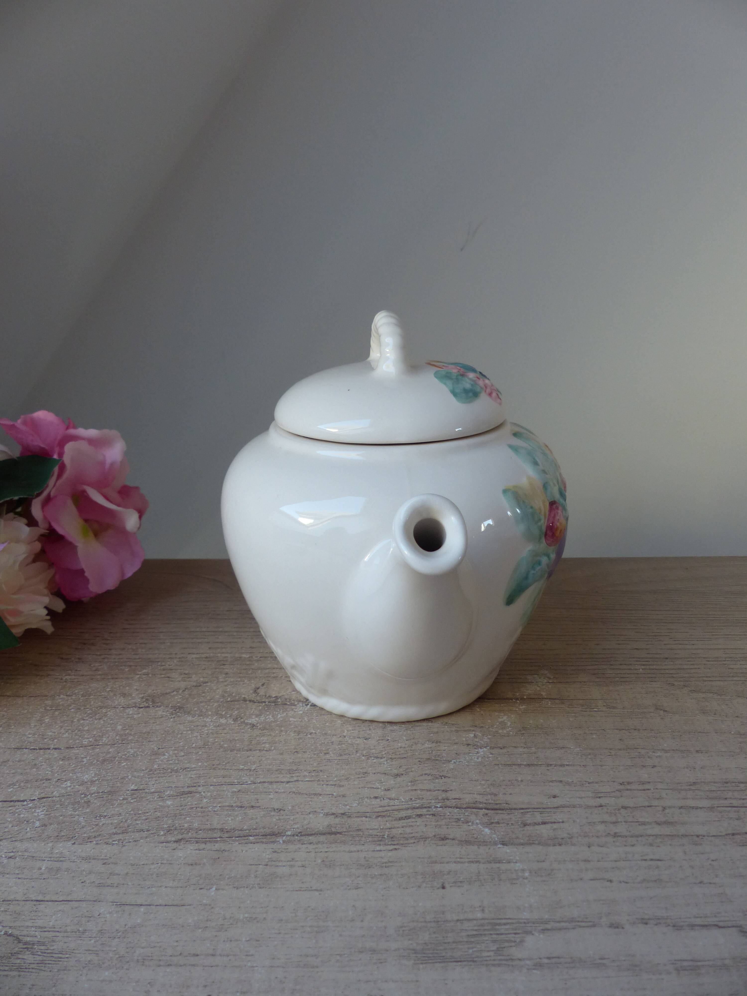 Old ceramic teapot in the shape of a basket of fruits from the garden