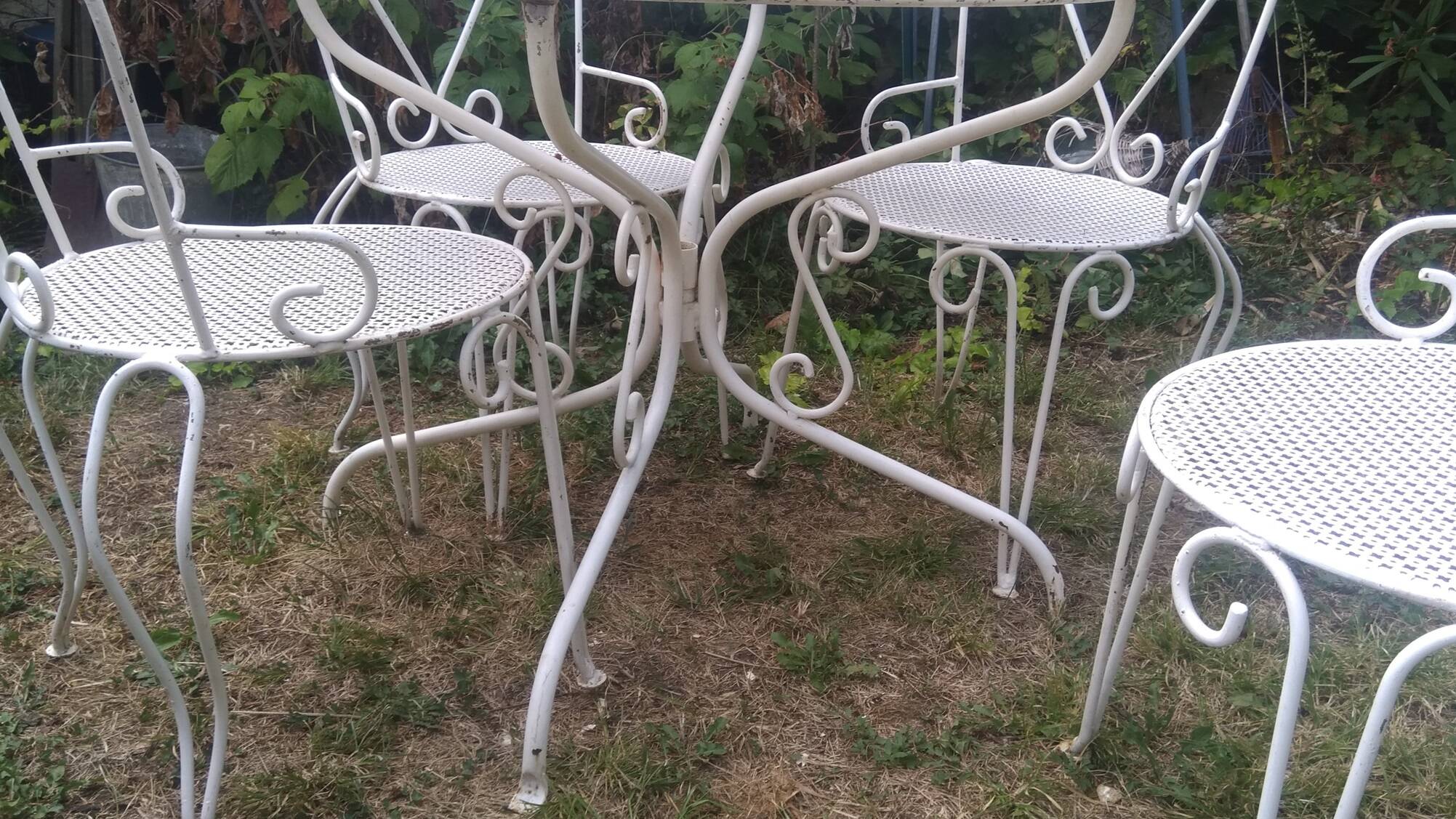 Mategot-style perforated wrought iron garden furniture with table and armchairs