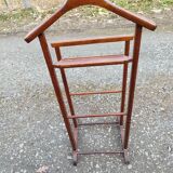 Valet wearing double wood coat rack