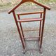 Valet wearing double wood coat rack