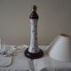 Table lamp for bedside use in earthenware with a wooden base.