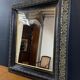 19th-century mirror Napoleon III in blackened wood on a gold background.