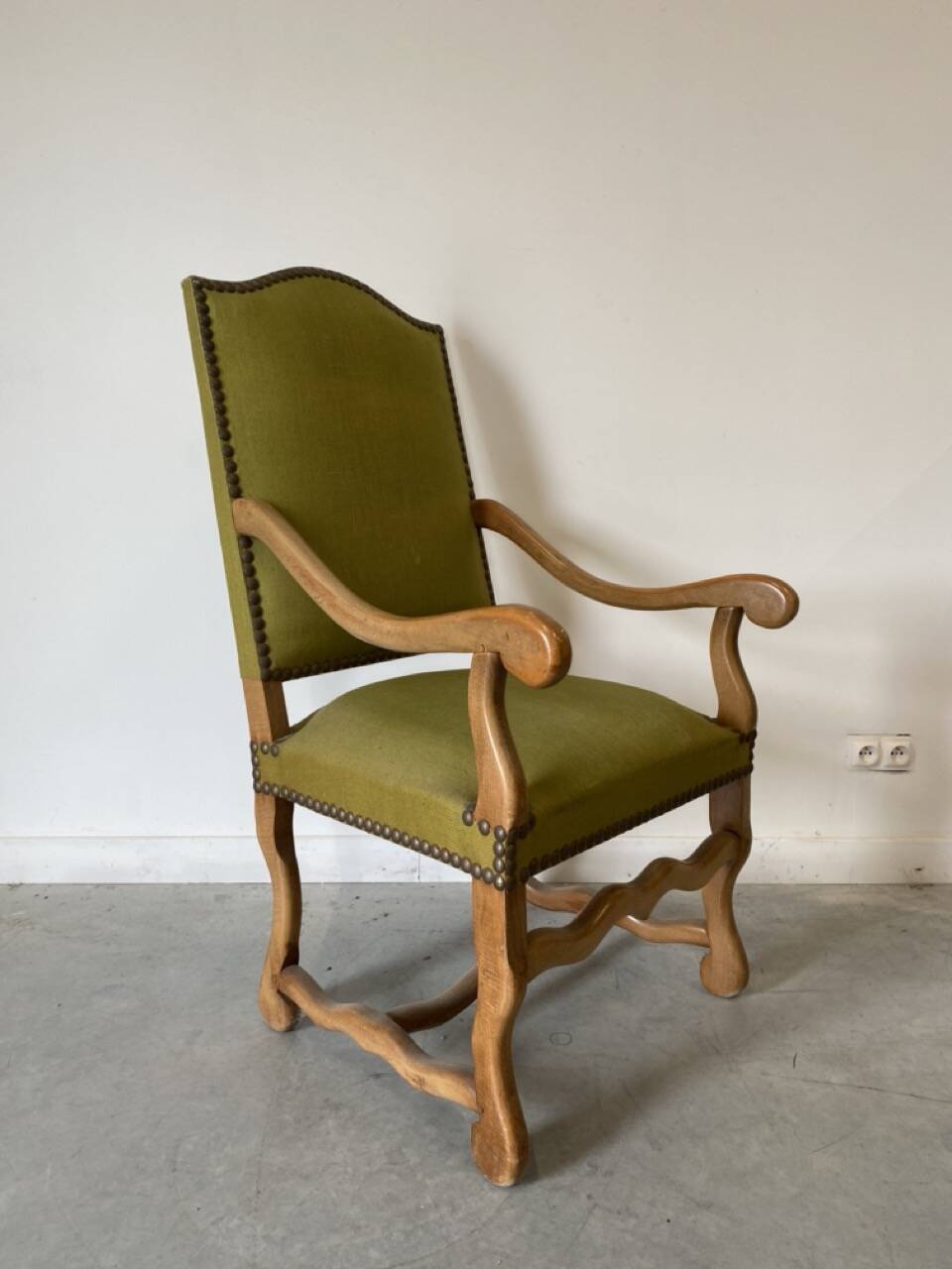 Olive green upholstered armchairs with studs