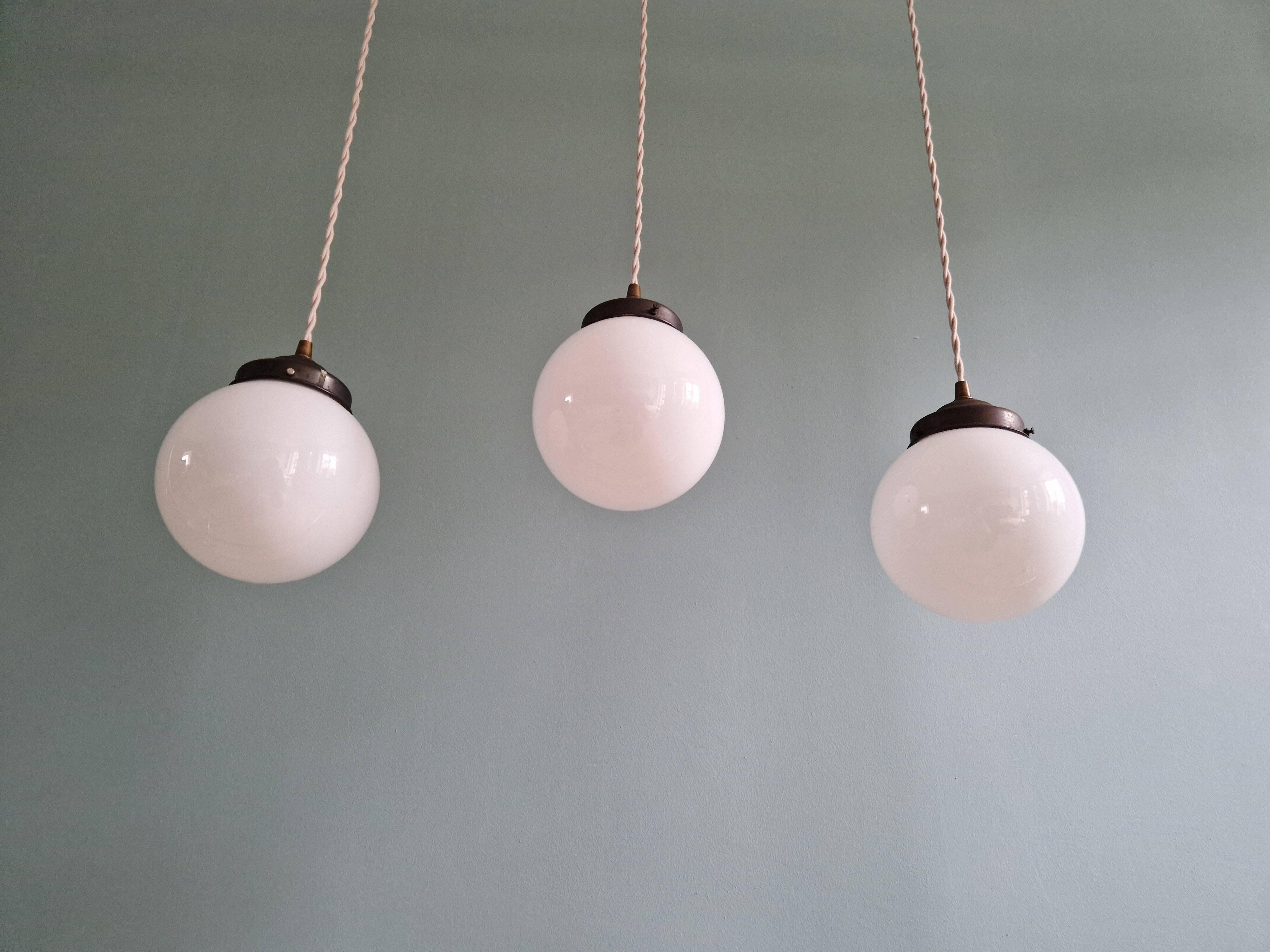 Art Deco trio of suspensions in white opaline, 1930s