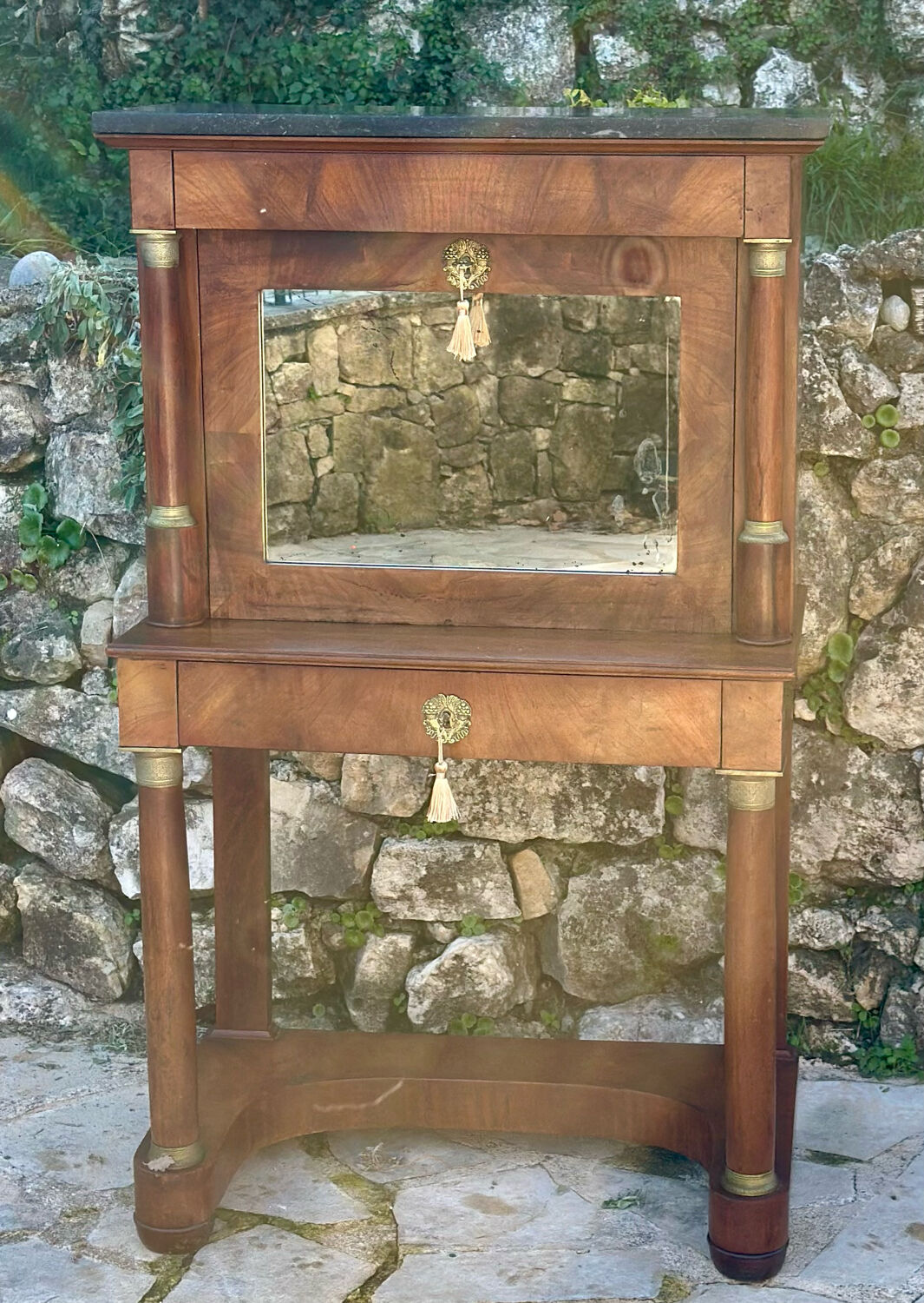 A small piece of Bonheur du jour with detached columns in Empire-era mahogany.