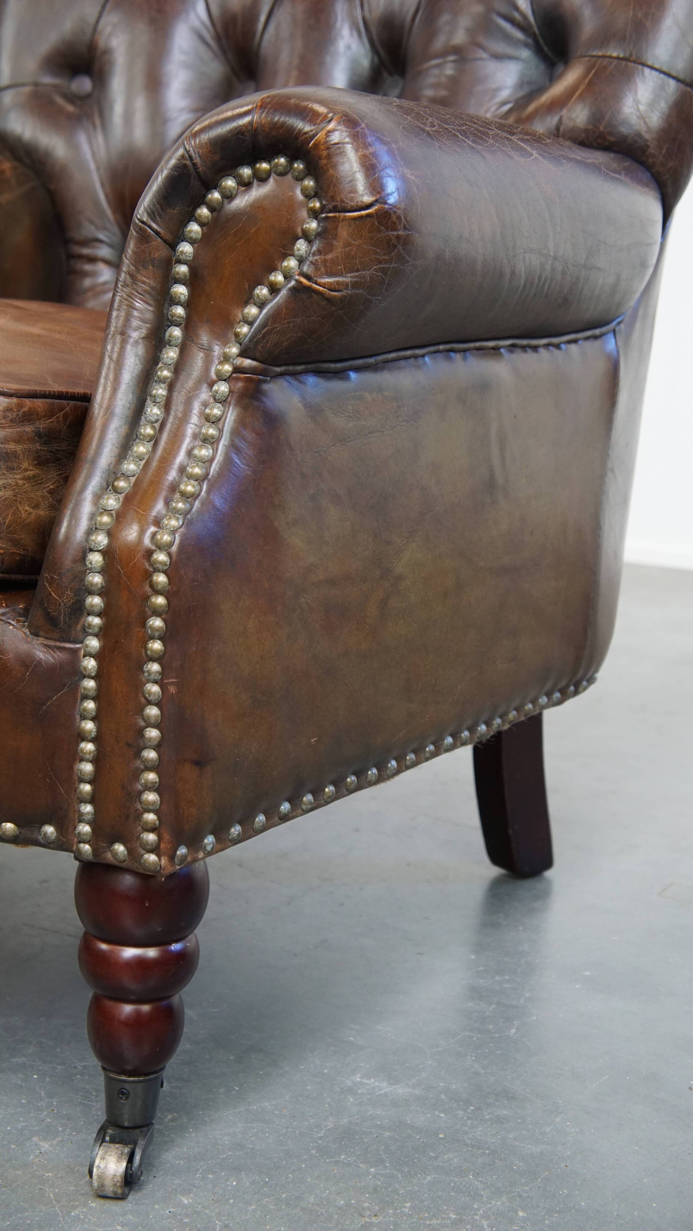 Cognac colored brown grained cowhide chesterfield armchair
