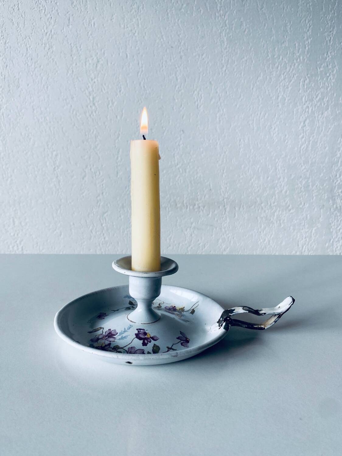 Antique enamelled metal candle holder