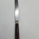 Set of 12 dessert knives with two-tone horn-effect resin handles.