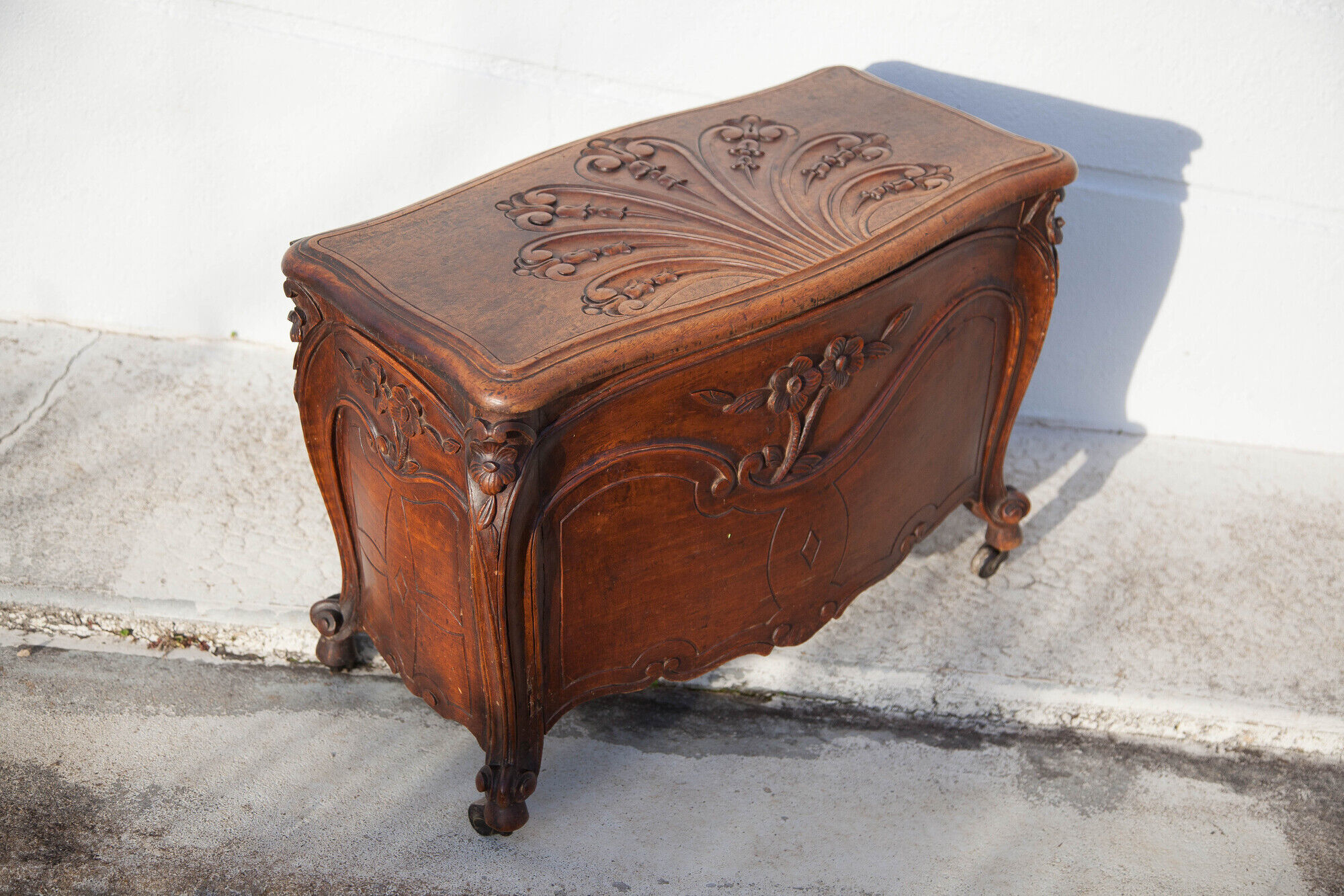 Old chest, carved wooden chest, curved chest on wheels, interior decoration