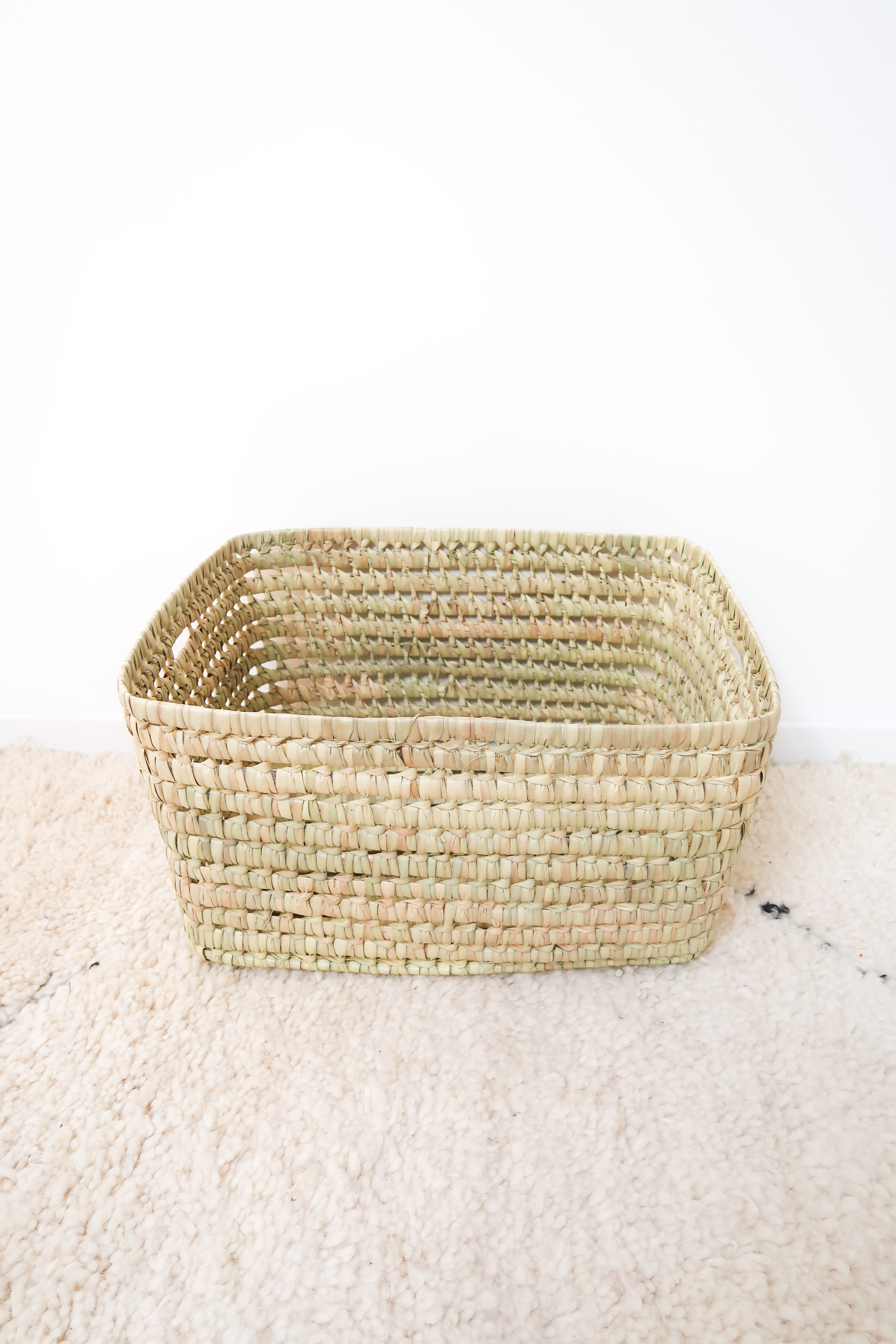 Storage basket in braided palm leaves