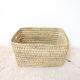 Storage basket in braided palm leaves