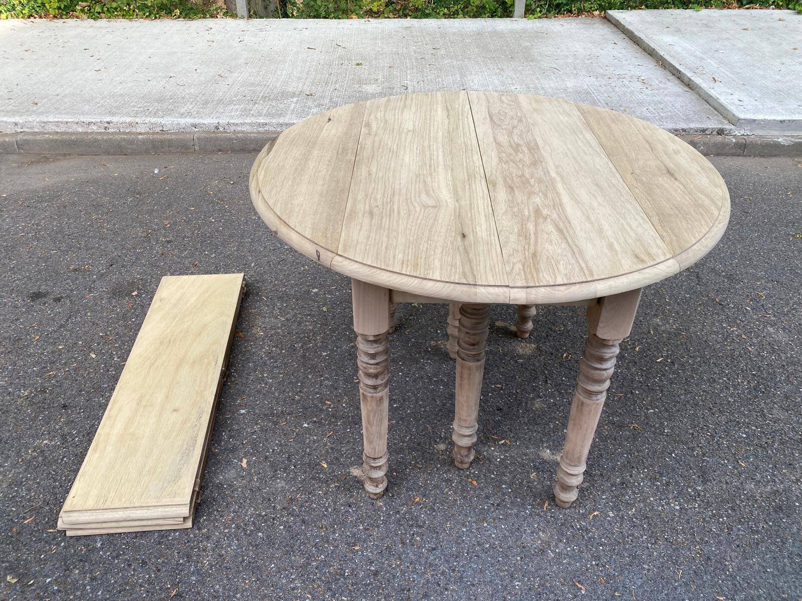 Round extendable dining table with flaps, stripped in raw oak, with 3 extensions.