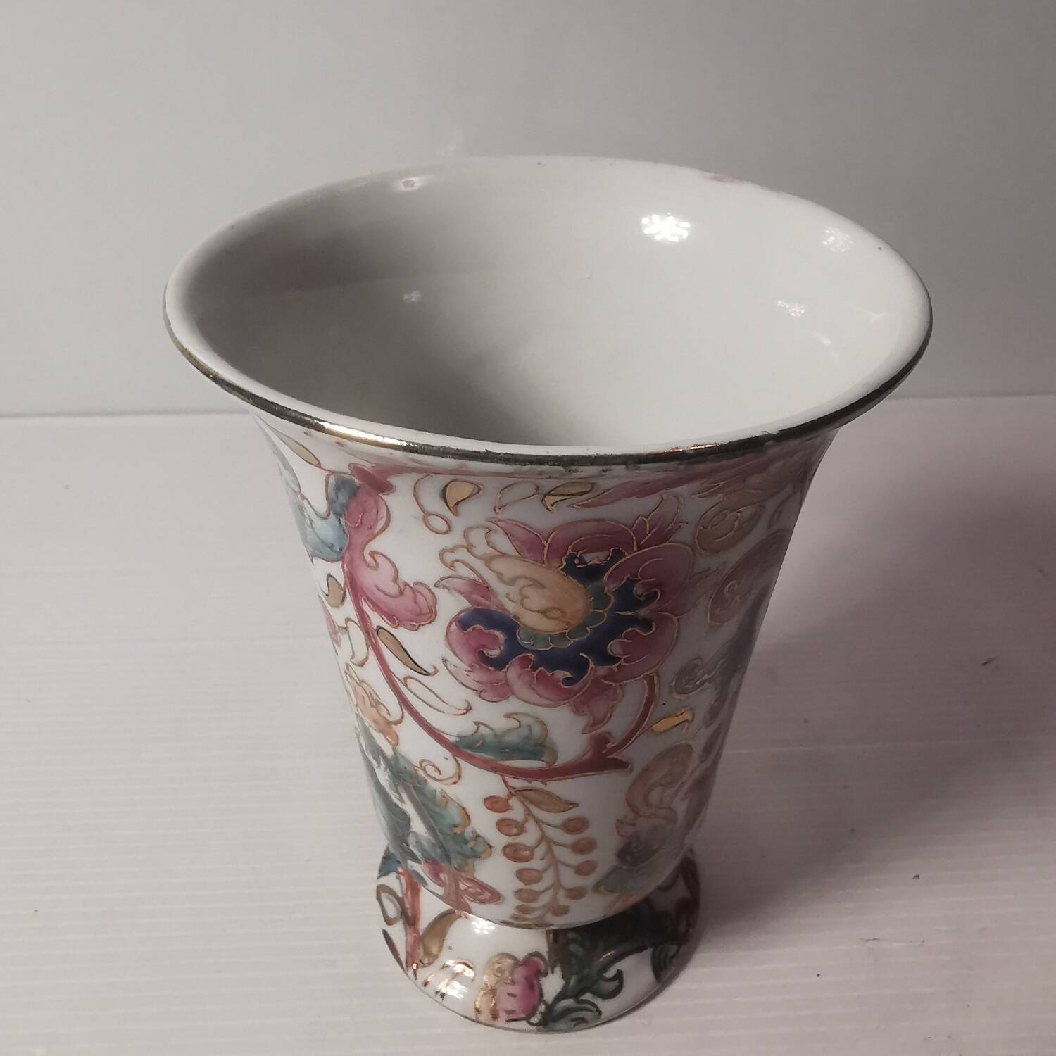 Old vintage vase with floral decor