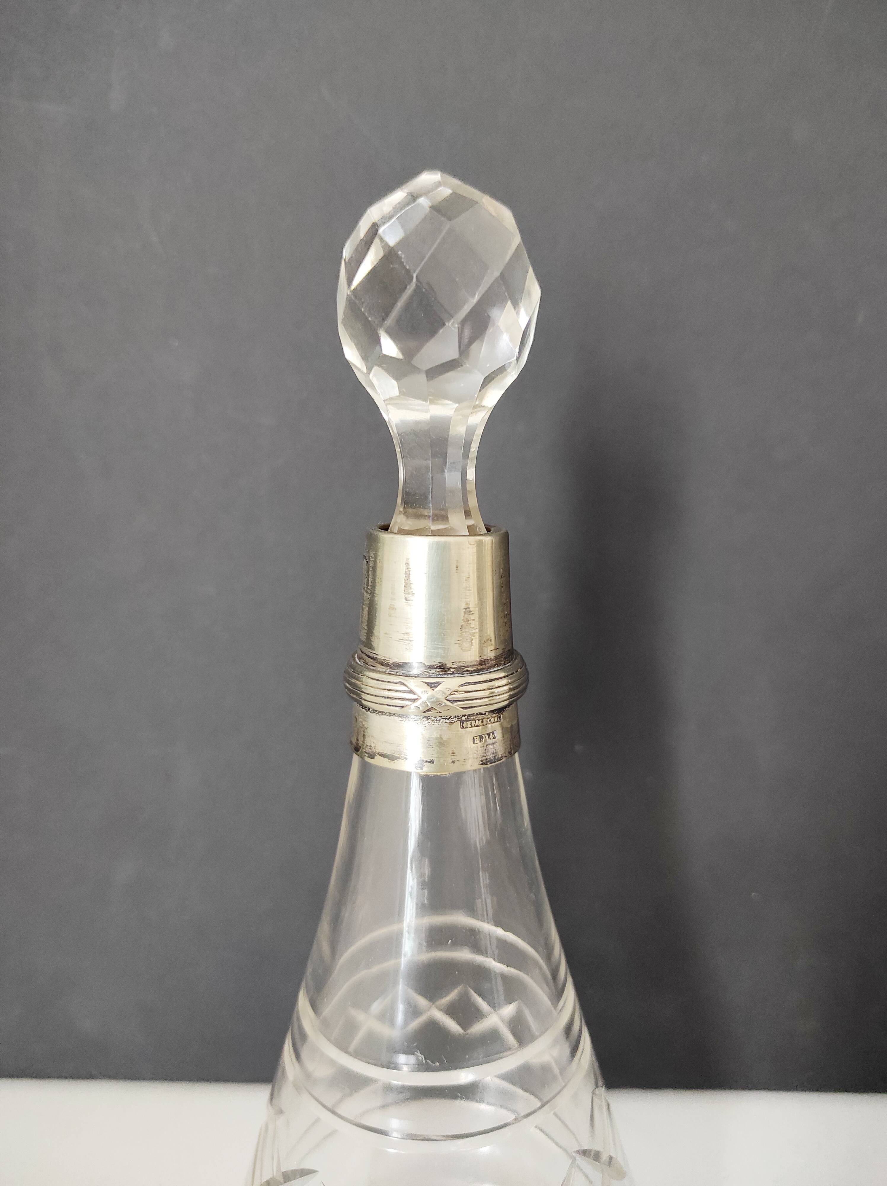 Crystal bottle with silver metal neck rim