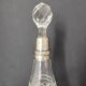 Crystal bottle with silver metal neck rim